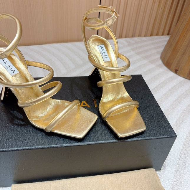 ALAIA THREE-STRAPS HIGH HEEL SANDALS IN GOLDEN PATENT LAMBSKIN