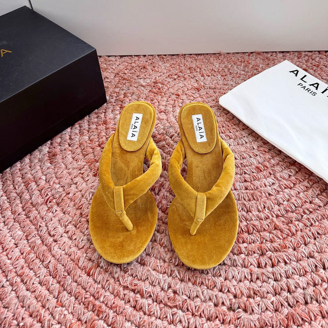 ALAIA 26S HEELED THONG SANDALS IN MUSTARD YELLOW VELVET