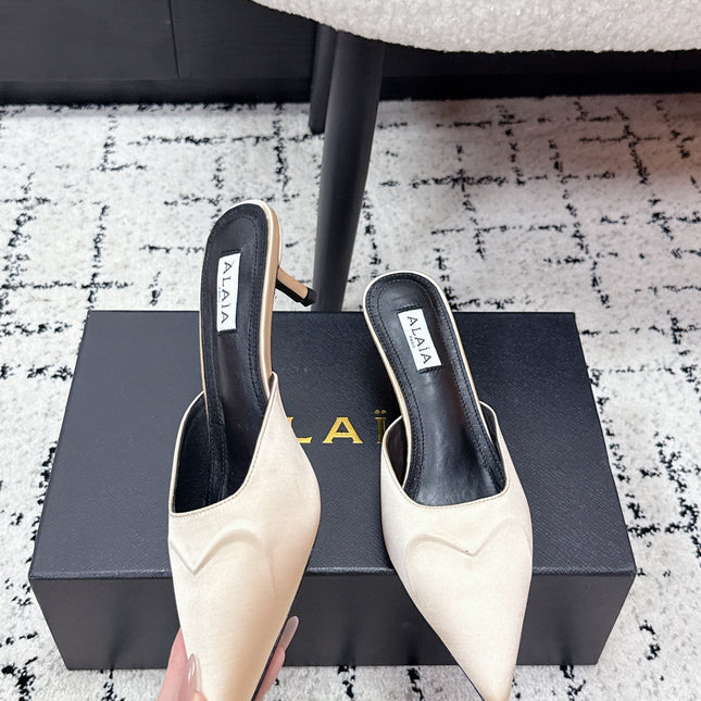 ALAIA 26S HEELED MULES 65 MM IN IVORY BEIGE SATIN