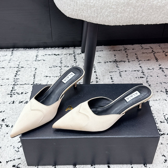 ALAIA 26S HEELED MULES 65 MM IN IVORY BEIGE SATIN