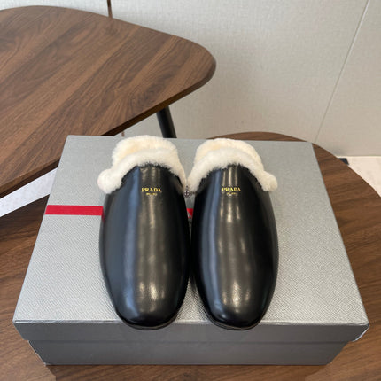PRADA 25S CLOGS IN BLACK CALFSKIN FUR-LINED