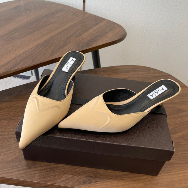 ALAIA 26S HEELED MULES 50 MM IN WARM BEIGE FABRIC