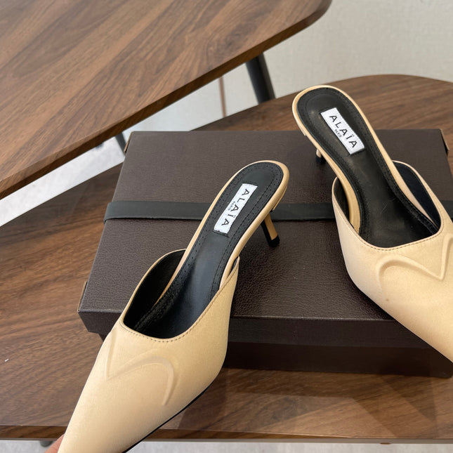 ALAIA 26S HEELED MULES 50 MM IN WARM BEIGE FABRIC