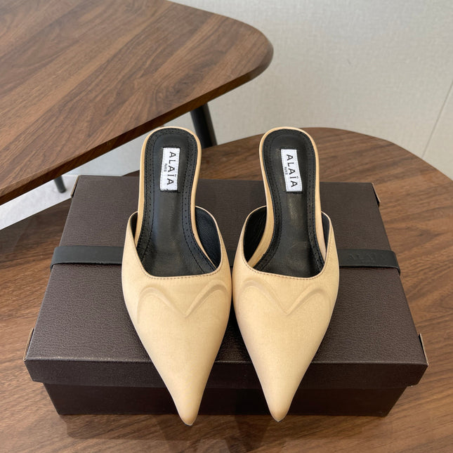 ALAIA 26S HEELED MULES 50 MM IN WARM BEIGE FABRIC
