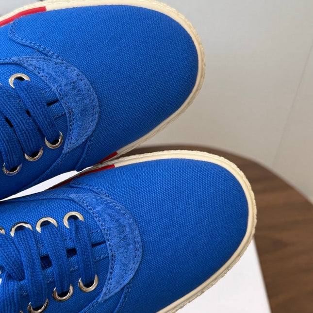 CELINE 26S TRIOMPHE LOW TOP SNEAKERS IN BLUE CANVAS RED TRIM