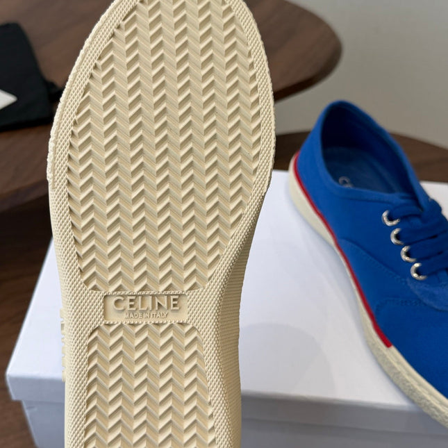 CELINE 26S TRIOMPHE LOW TOP SNEAKERS IN BLUE CANVAS RED TRIM