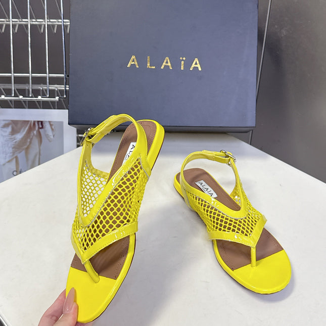 ALAIA 26S FLAT MESH THONG SANDALS IN YELLOW PATENT CALFSKIN