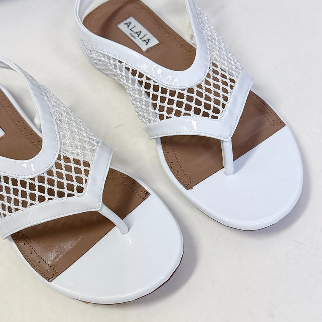 ALAIA 26S FLAT MESH THONG SANDALS IN WHITE PATENT CALFSKIN