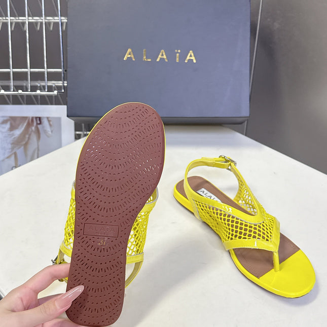 ALAIA 26S FLAT MESH THONG SANDALS IN YELLOW PATENT CALFSKIN