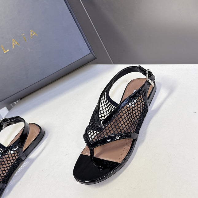 ALAIA 26S FLAT MESH THONG SANDALS IN BLACK PATENT CALFSKIN