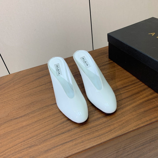 ALAIA 26S WEDGE MULES 70 MM IN WHITE GLOSSY CALFSKIN