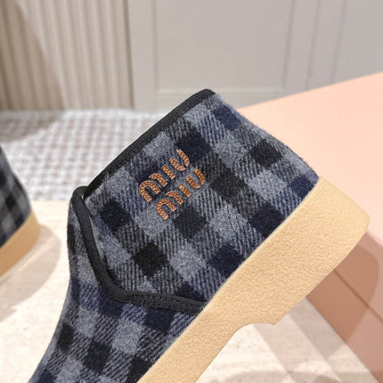 MIUMIU 25S SLIP-ON BOOTIES IN BLACK AND BLUE WOOL WITH SHEARLING
