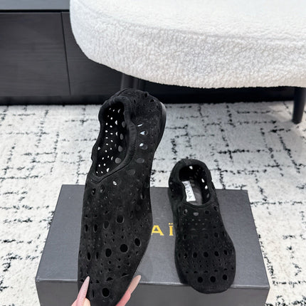 ALAIA 26S FLAT SLIP-ONS IN BLACK SUEDE WITH OPENWORK PATTERN