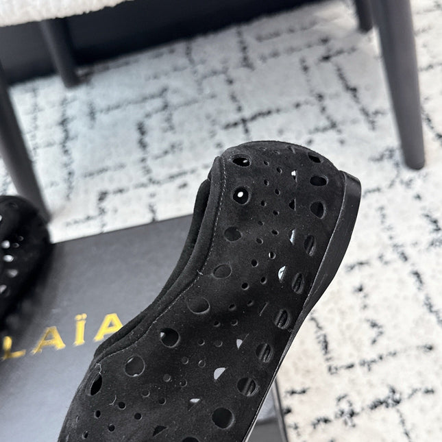 ALAIA 26S FLAT SLIP-ONS IN BLACK SUEDE WITH OPENWORK PATTERN