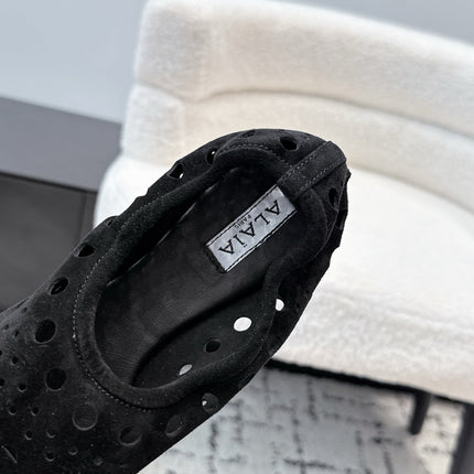 ALAIA 26S FLAT SLIP-ONS IN BLACK SUEDE WITH OPENWORK PATTERN