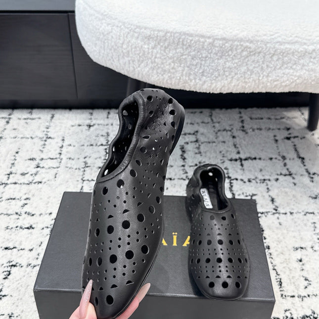 ALAIA 26S FLAT SLIP-ONS IN BLACK CALFSKIN WITH OPENWORK PATTERN