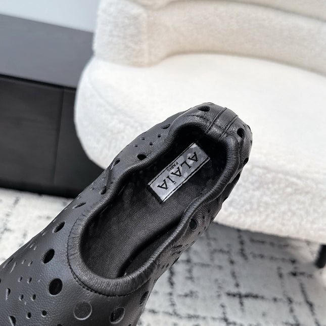 ALAIA 26S FLAT SLIP-ONS IN BLACK CALFSKIN WITH OPENWORK PATTERN