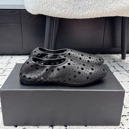 ALAIA 26S FLAT SLIP-ONS IN BLACK CALFSKIN WITH OPENWORK PATTERN