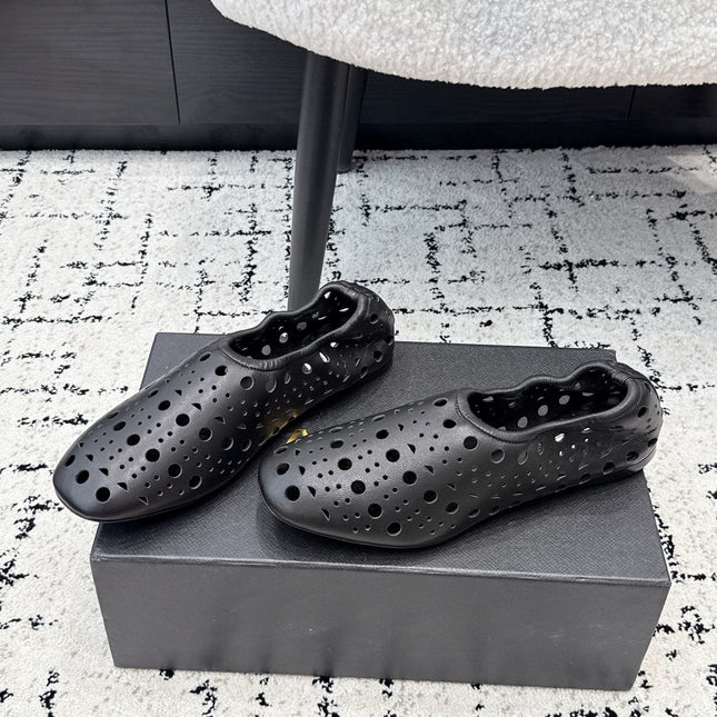 ALAIA 26S FLAT SLIP-ONS IN BLACK CALFSKIN WITH OPENWORK PATTERN