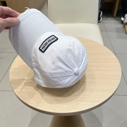 MIUMIU DISTRESSED FABRIC BASEBALL CAP IN WHITE WITH EMBROIDERED LOGO