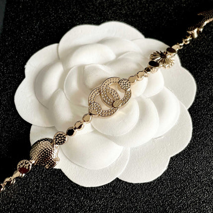 CHANEL 26S DOUBLE C LOGO CRYSTAL MULTI-CHARM STATEMENT BRACELET IN GOLD METAL 629170