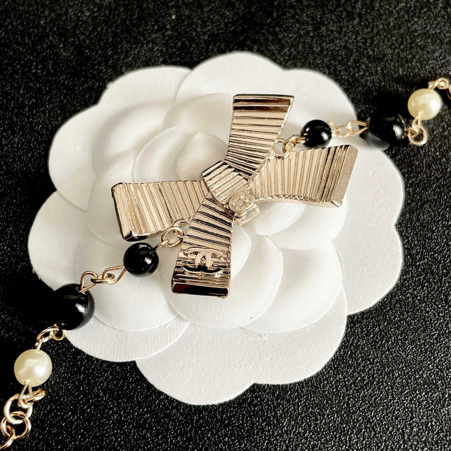 CHANEL 26S CRYSTAL BOW PEARL & BEAD CHAIN BRACELET IN GOLD METAL 629979