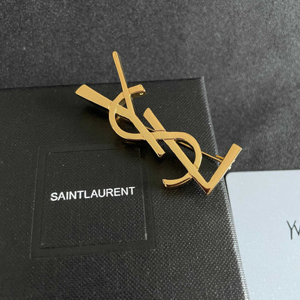 YSL 26S MONOGRAM BROOCH IN GOLD TONE METAL 630942