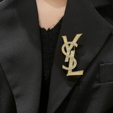YSL 26S CRYSTAL MONOGRAM BROOCH IN GOLD TONE METAL 631043