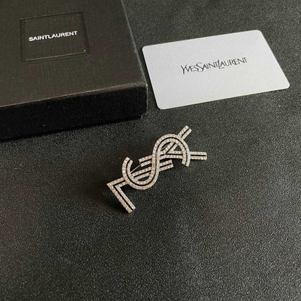 YSL 26S CRYSTAL LOGO BROOCH IN SILVER TONE METAL 634974