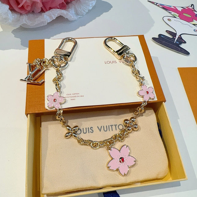 SAKURA BAG CHARM IN GOLD METAL HARDWARE