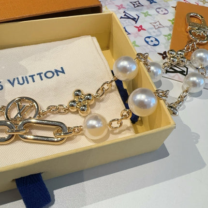 GOLD-TONE BAG CHAIN WITH PEARL DETAILS AND A LOGO CHARM