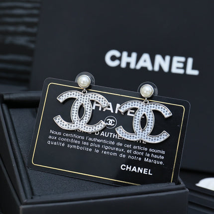 DOUBLE C EARRINGS IN SILVER METAL WITH BLACK SNOWFLAKE EMBOSSED ON WHITE ENAMEL