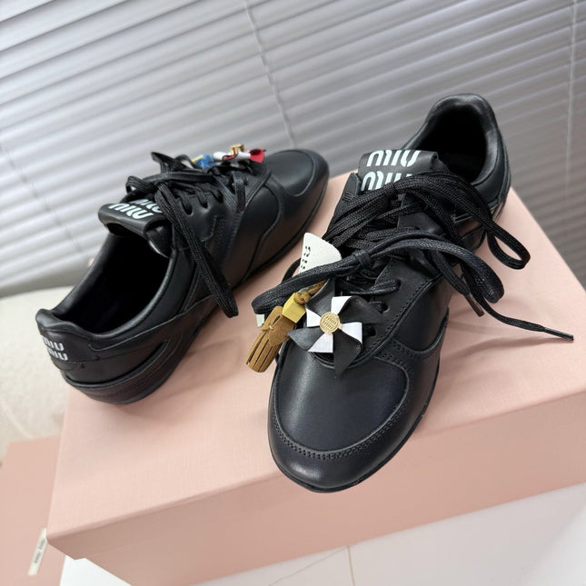 MIUMIU 26S GYMNASIUM SNEAKER IN BLACK CALFSKIN WITH GOLD BUCKLED STRAP