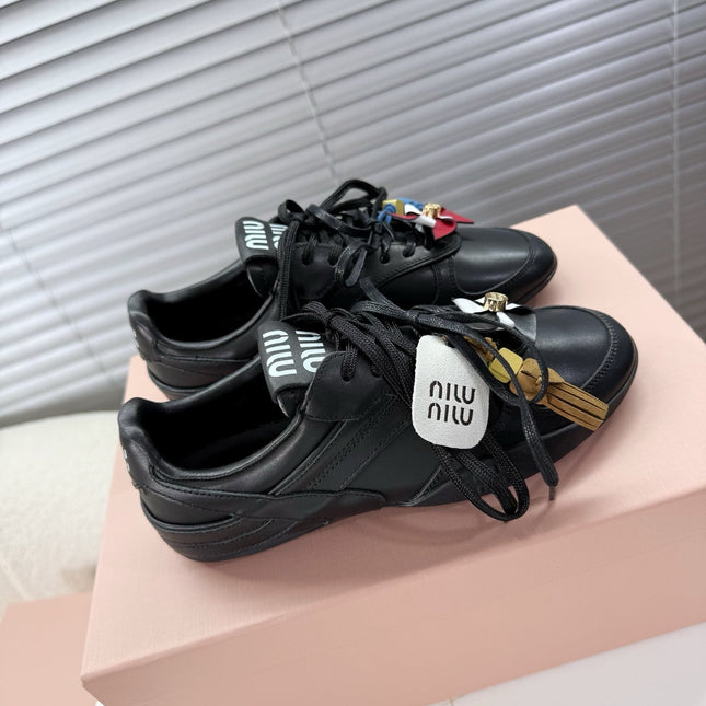 MIUMIU 26S GYMNASIUM SNEAKER IN BLACK CALFSKIN WITH GOLD BUCKLED STRAP