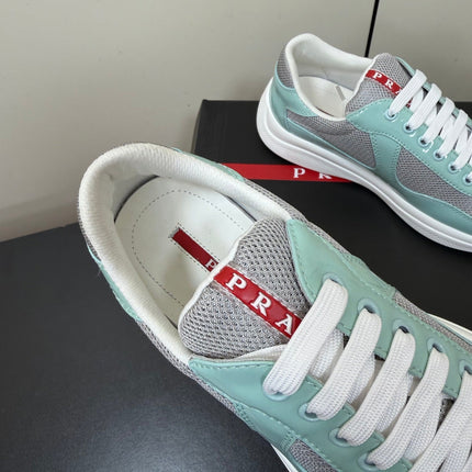 PRADA 26S SNEAKERS IN SOFT TEAL PATENT CALFSKIN AND WHITE MESH