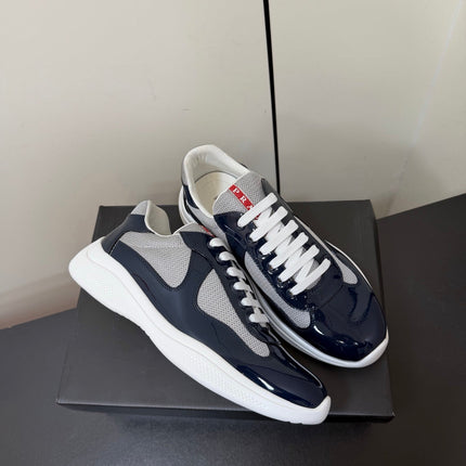 PRADA 26S SNEAKERS IN NAVY BLUE PATENT CALFSKIN AND WHITE MESH