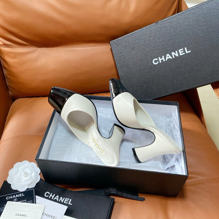 CHANEL 26S HIGH-HEEL MULES 90 MM IN BLACK AND WHITE LAMBSKIN