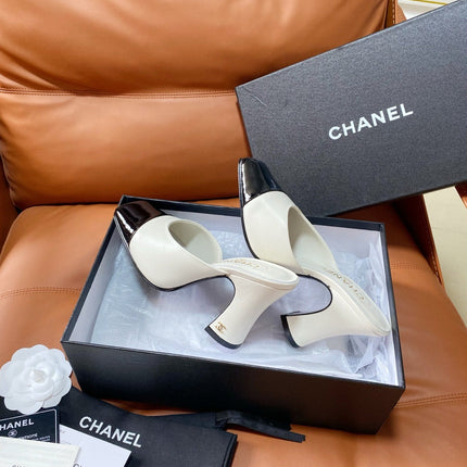 CHANEL 26S HIGH-HEEL MULES 90 MM IN BLACK AND WHITE LAMBSKIN
