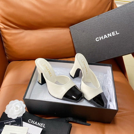 CHANEL 26S HIGH-HEEL MULES 90 MM IN BLACK AND WHITE LAMBSKIN