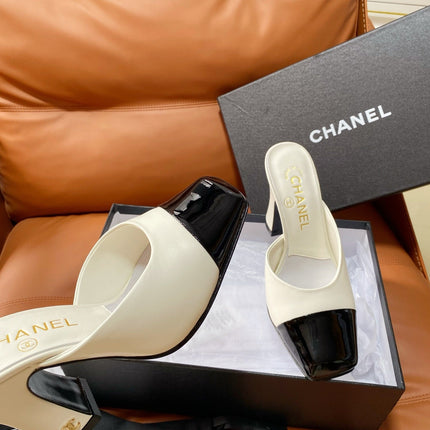 CHANEL 26S HIGH-HEEL MULES 90 MM IN BLACK AND WHITE LAMBSKIN