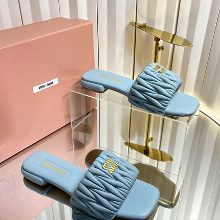 MIUMIU 26S MATELASSE SLIDES IN LIGHT BLUE CALFSKIN GOLD HARDWARE