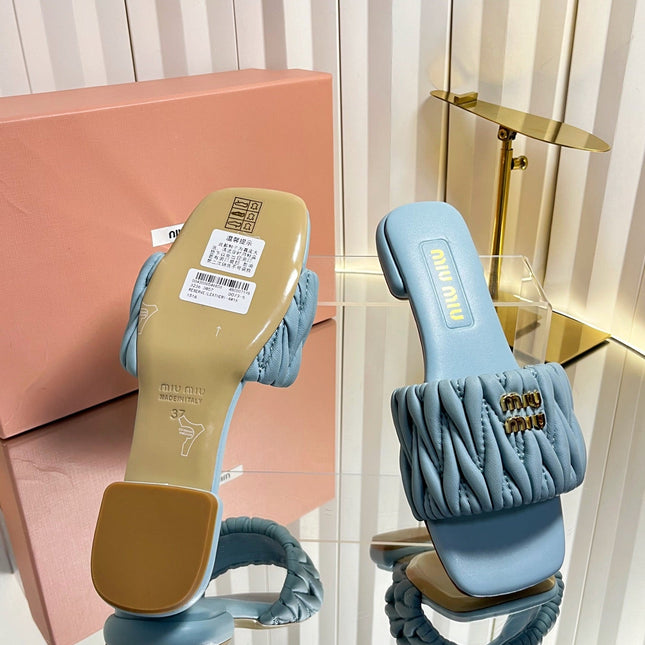 MIUMIU 26S MATELASSE SLIDES IN LIGHT BLUE CALFSKIN GOLD HARDWARE