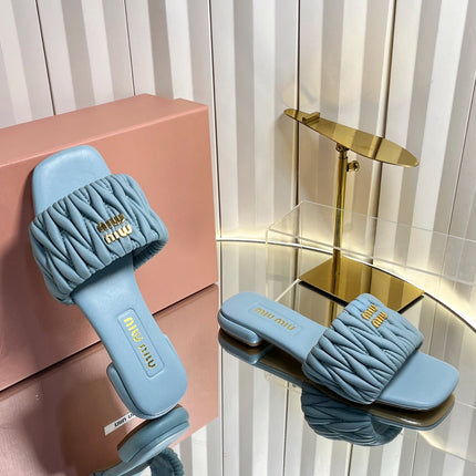 MIUMIU 26S MATELASSE SLIDES IN LIGHT BLUE CALFSKIN GOLD HARDWARE