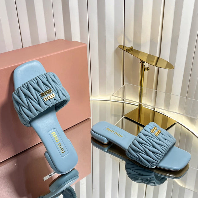 MIUMIU 26S MATELASSE SLIDES IN LIGHT BLUE CALFSKIN GOLD HARDWARE