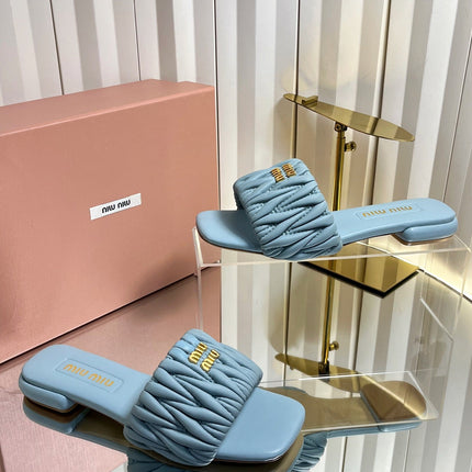 MIUMIU 26S MATELASSE SLIDES IN LIGHT BLUE CALFSKIN GOLD HARDWARE