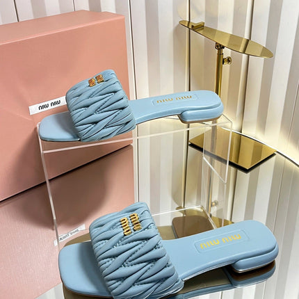 MIUMIU 26S MATELASSE SLIDES IN LIGHT BLUE CALFSKIN GOLD HARDWARE