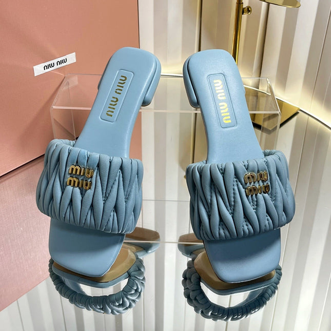 MIUMIU 26S MATELASSE SLIDES IN LIGHT BLUE CALFSKIN GOLD HARDWARE