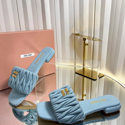 MIUMIU 26S MATELASSE SLIDES IN LIGHT BLUE CALFSKIN GOLD HARDWARE