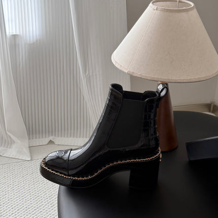 CHANEL 26S CHELSEA ANKLE BOOTS 70 MM IN BLACK EMBOSSED AND PATENT