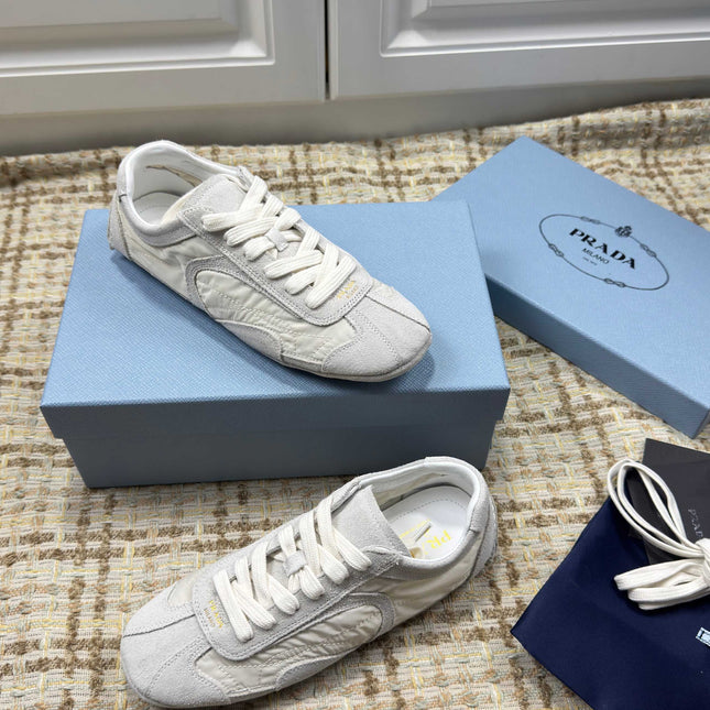 PRADA 26S LOW TOP SNEAKERS IN WHITE NYLON AND SUEDE